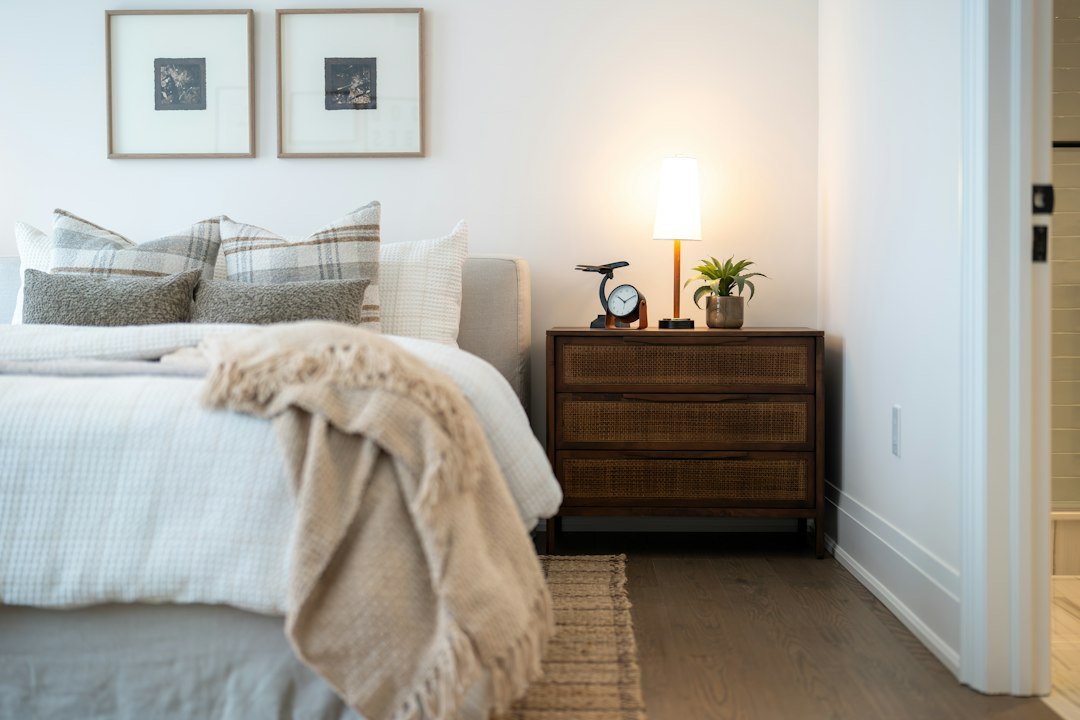 A cozy bedroom with a bedside table and lamp