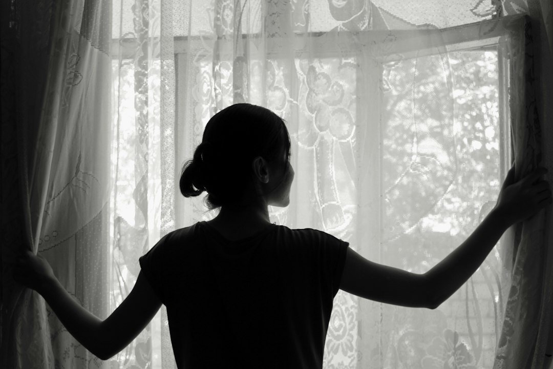 silhouette of woman opening window