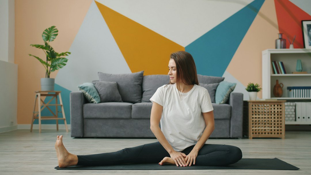 Woman stretching on a yoga mat in living room